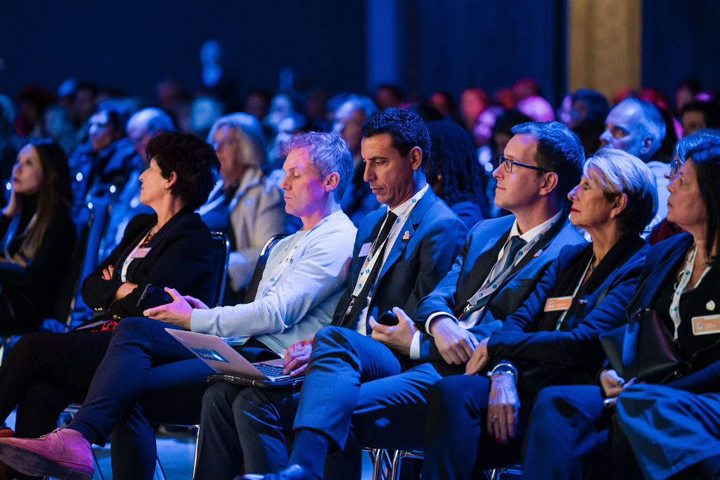 IPIC2023: A row of conference participants, focused and listening intently to the speaker at the front.